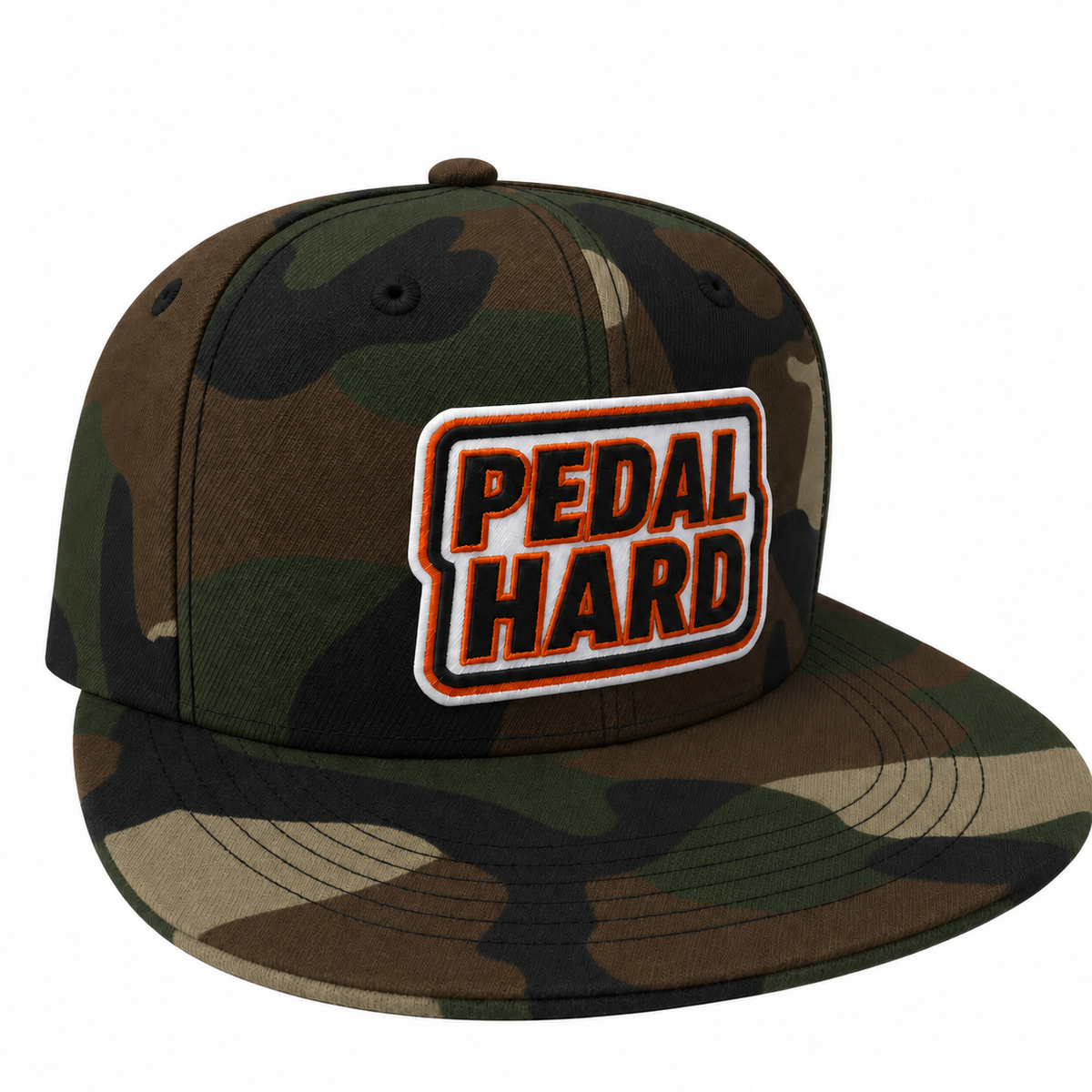 A flat-brim snapback cap in a woodland camouflage pattern, featuring a prominent rectangular embroidered patch on the front with the text 'PEDAL HARD' in orange and black.