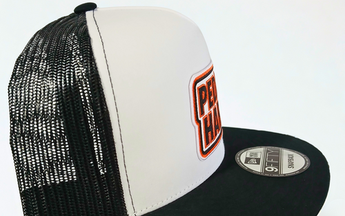 PEDAL HARD Bmore Classic snapback hat angled front view showing Bmore Orange PEDAL HARD patch white front panel and flat bill