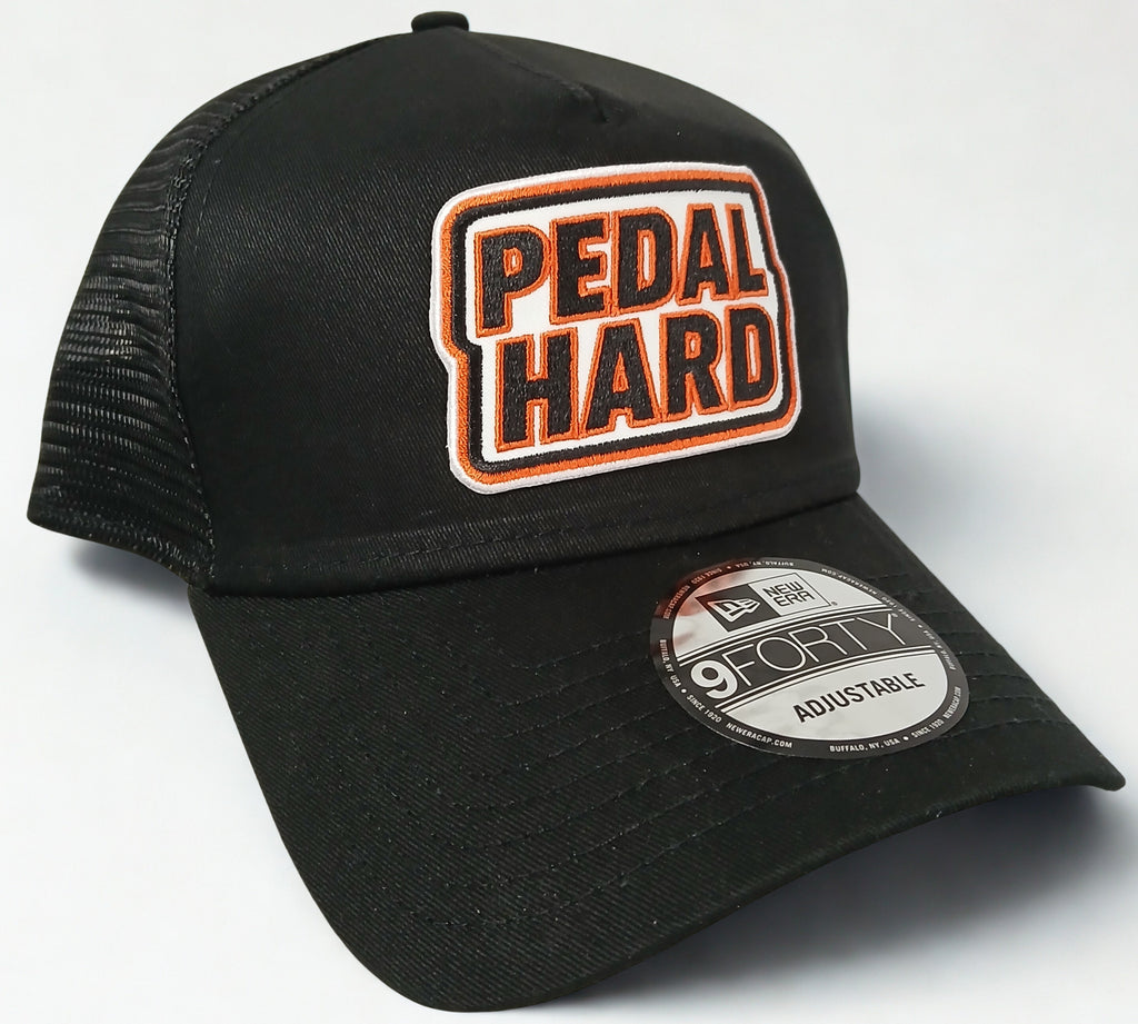 PEDAL HARD Cityline Trucker snapback hat front view black trucker hat with Bmore Orange logo for BMX MTB and cycling riders
