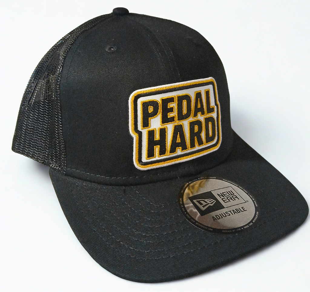 PEDAL HARD Hardline Trucker snapback hat front view black trucker cap with mesh back and flat bill streetwear cycling hat